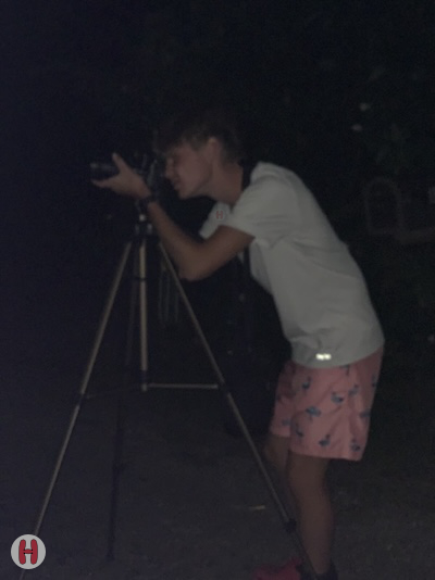 Henry taking a picture at night